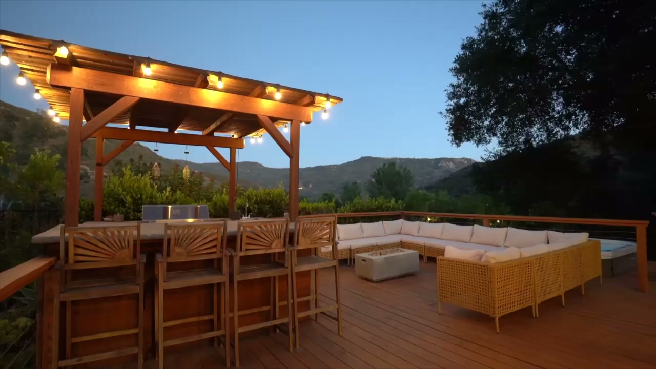 Golden-hour view of the DreamsAwake spa deck, pergola bar, and canyon mountains