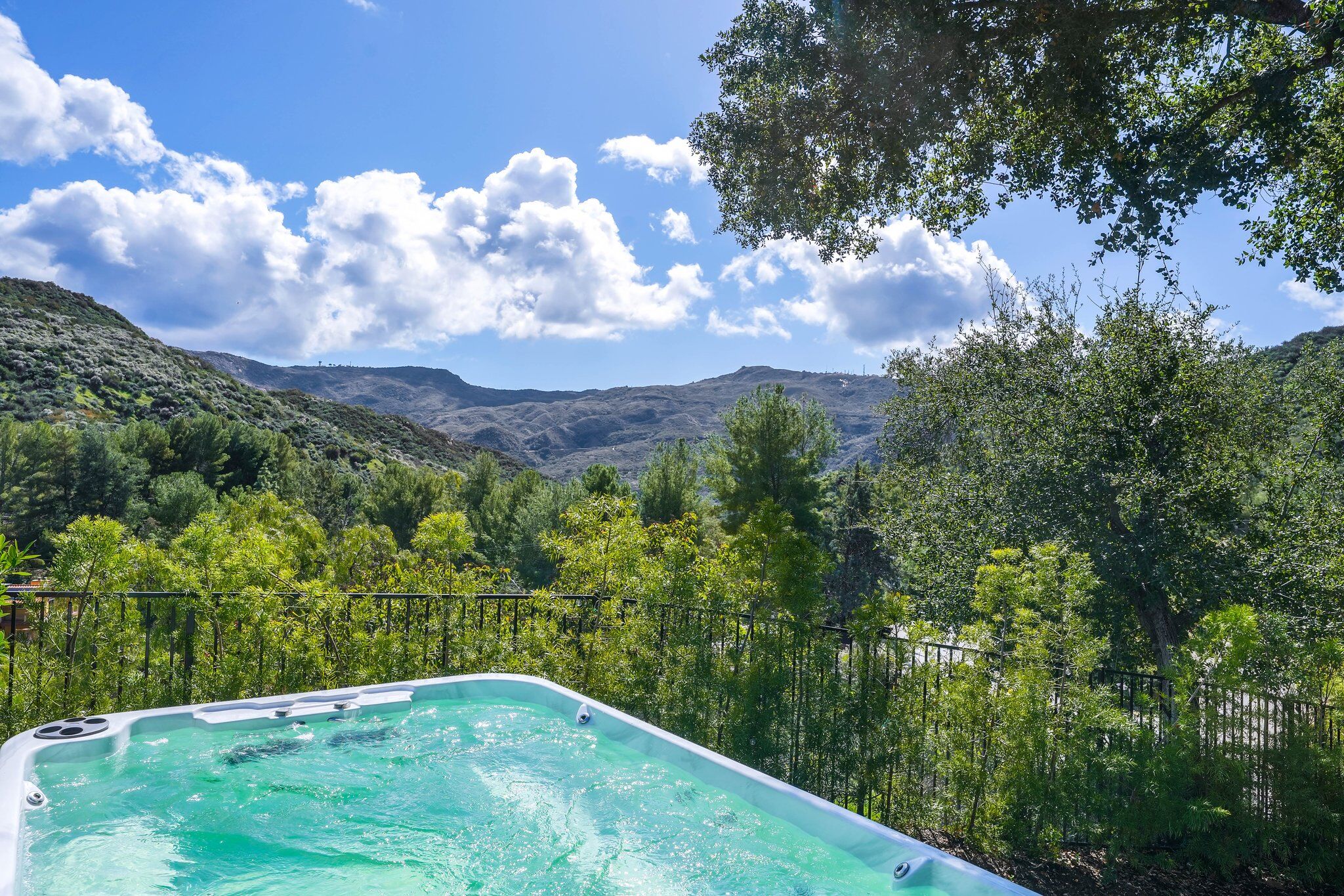 Swim spa edge looking straight down the canyon, ridgelines stacked to the horizon