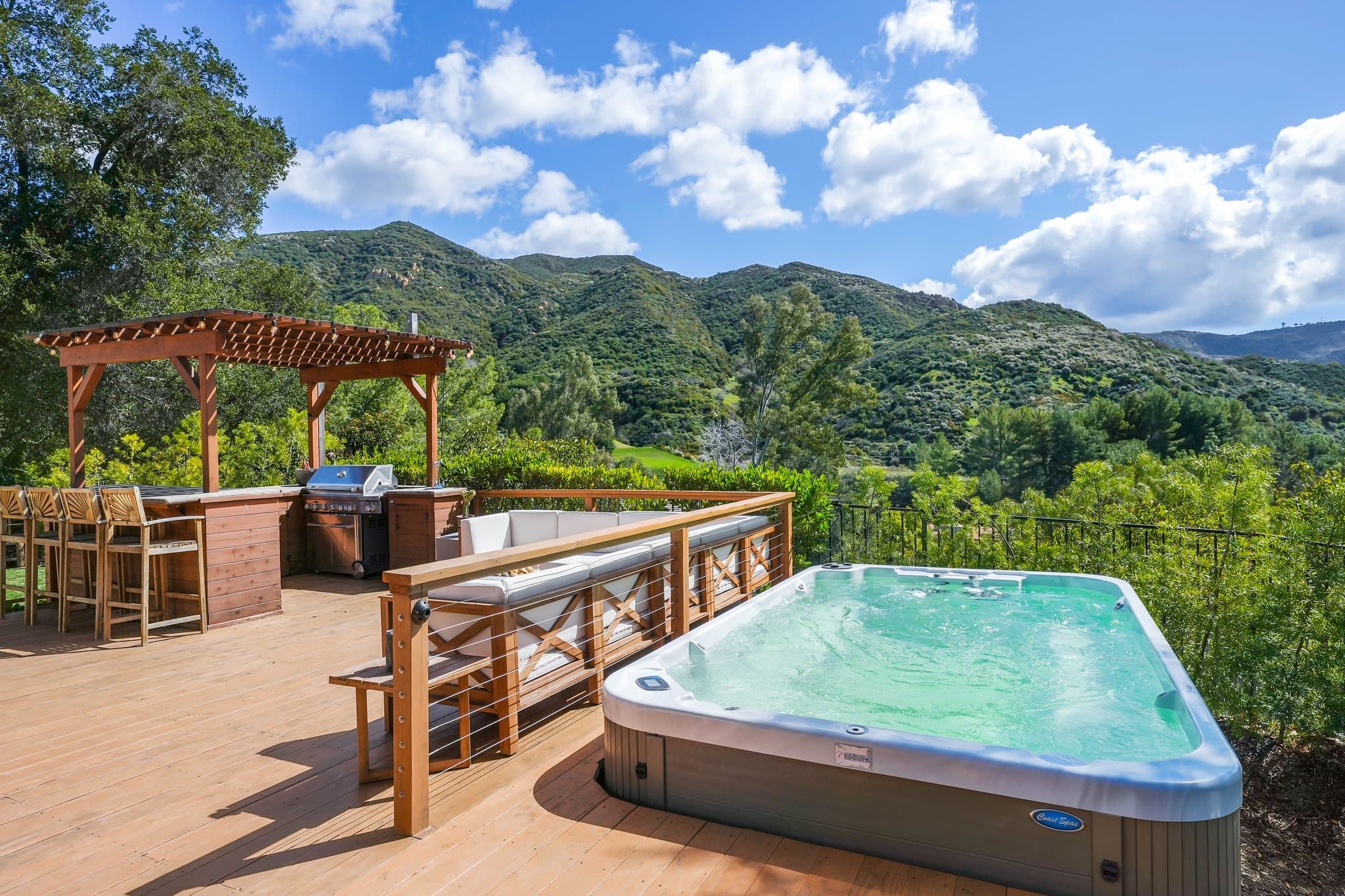 Spa deck with swim spa, pergola bar, and panoramic canyon mountain views